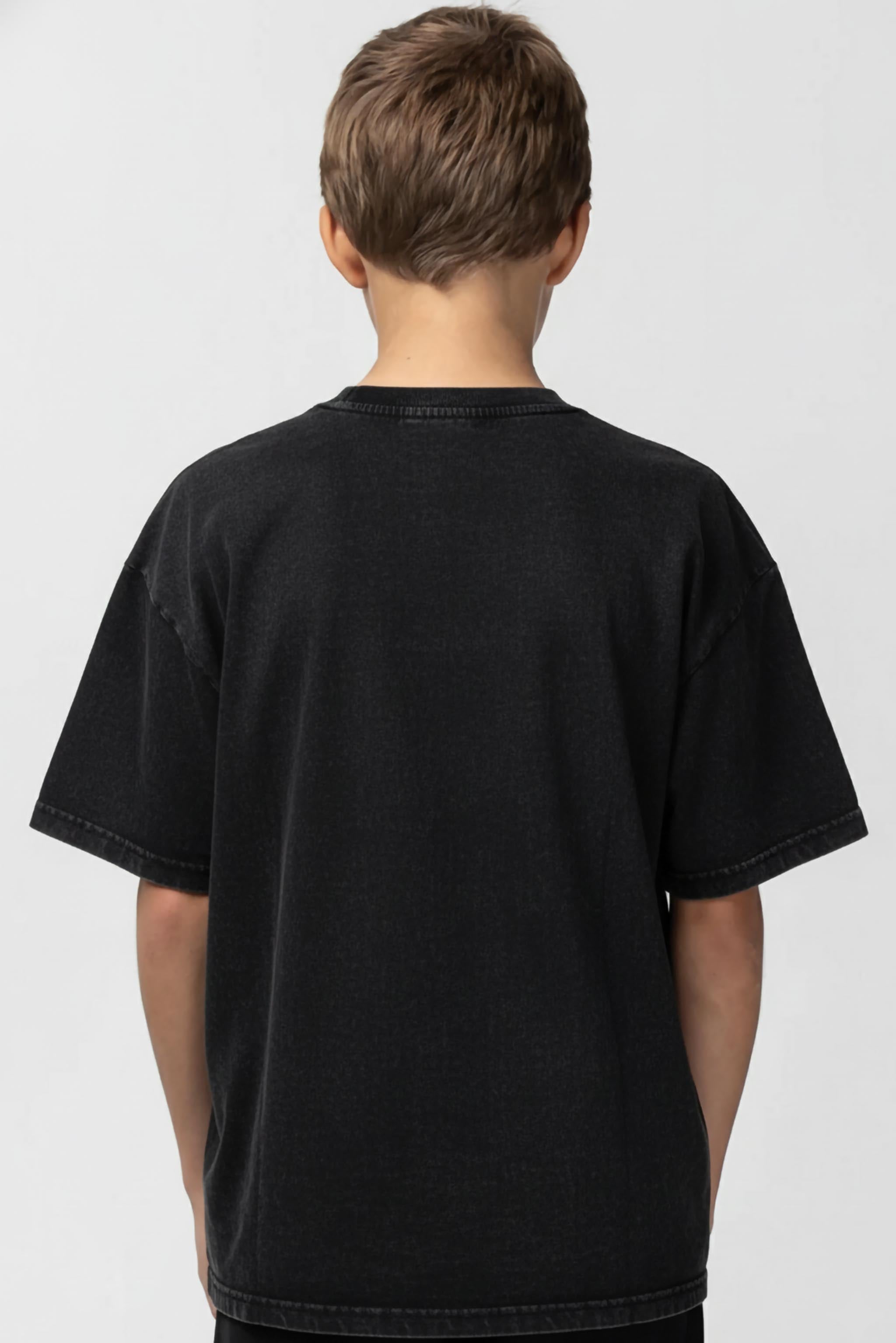 Person wearing a plain black t-shirt on a white background